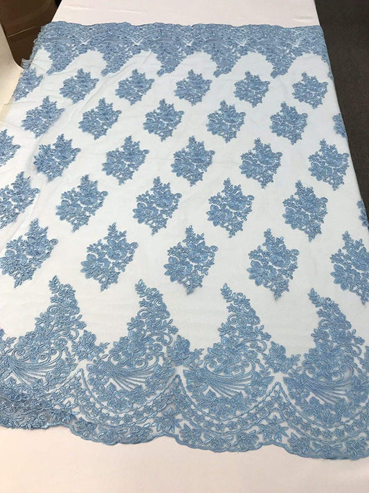 BABY BLUE FLORAL DESIGN WITH CORD EMBROIDERY ON A MESH LACE-SOLD BY YARD.