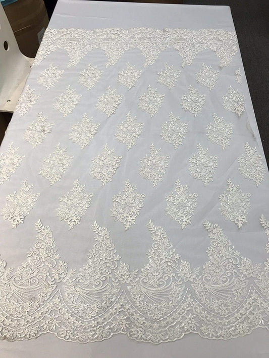 IVORY FLORAL DESIGN WITH CORD EMBROIDERY ON A MESH LACE-SOLD BY YARD.
