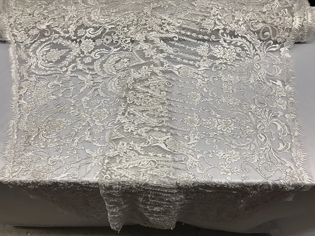 WHITE DIVA DESIGN EMBROIDERY WITH HEAVY BEADED ON A MESH-SOLD BY YARD.