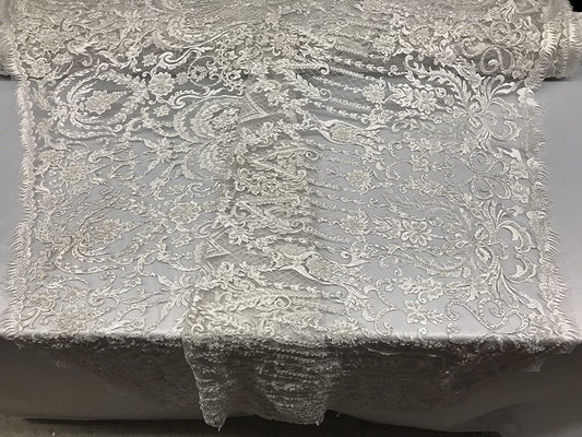 WHITE DIVA DESIGN EMBROIDERY WITH HEAVY BEADED ON A MESH-SOLD BY YARD.
