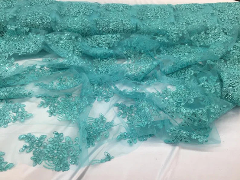 Aqua flower lace corded and embroider with sequins on a mesh. Wedding/bridal/prom/nightgown fabric sold by the yar