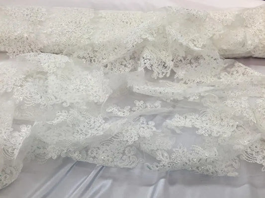 Ivory flower lace carded and embroider with sequins on a mesh. Wedding/bridal/prom/nightgown fabric sold by the yard