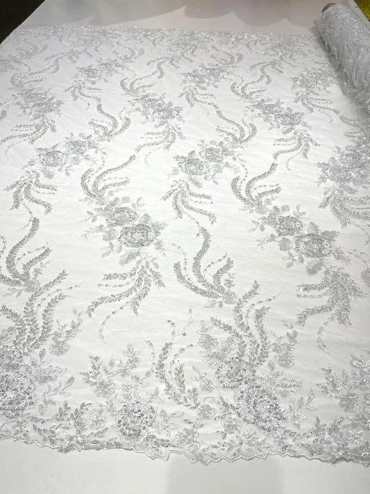 White flowers embroider and heavy beaded on a mesh lace fabric-sold by the yard.