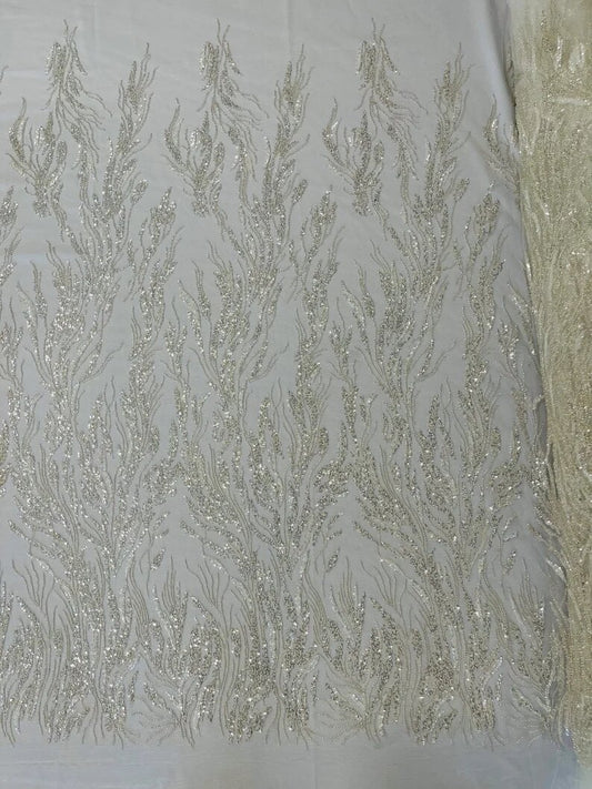 Fancy Design Embroider and heavy beading on a mesh lace-sold by the yard. Off White