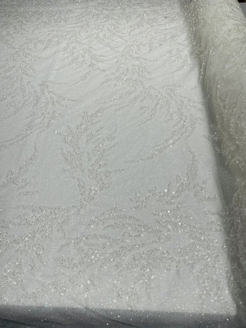 Elegant hand beaded design embroider on a glitter mesh lace-prom-sold by the yard. Clear/White