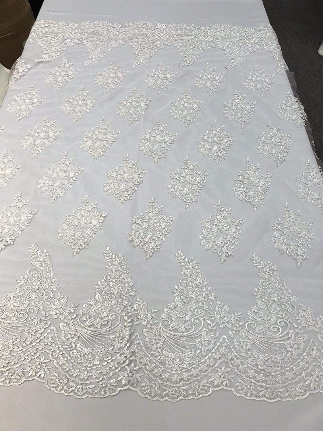WHITE FLORAL DESIGN WITH CORD EMBROIDERY ON A MESH LACE-SOLD BY YARD.