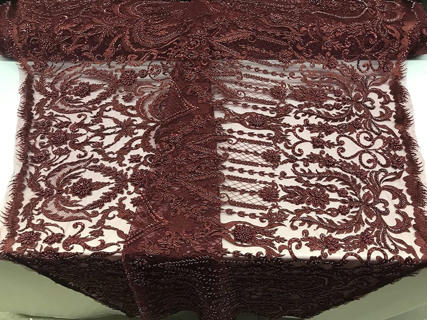 BURGUNDY DIVA DESIGN EMBROIDERY WITH HEAVY BEADED ON A MESH-SOLD BY YARD.