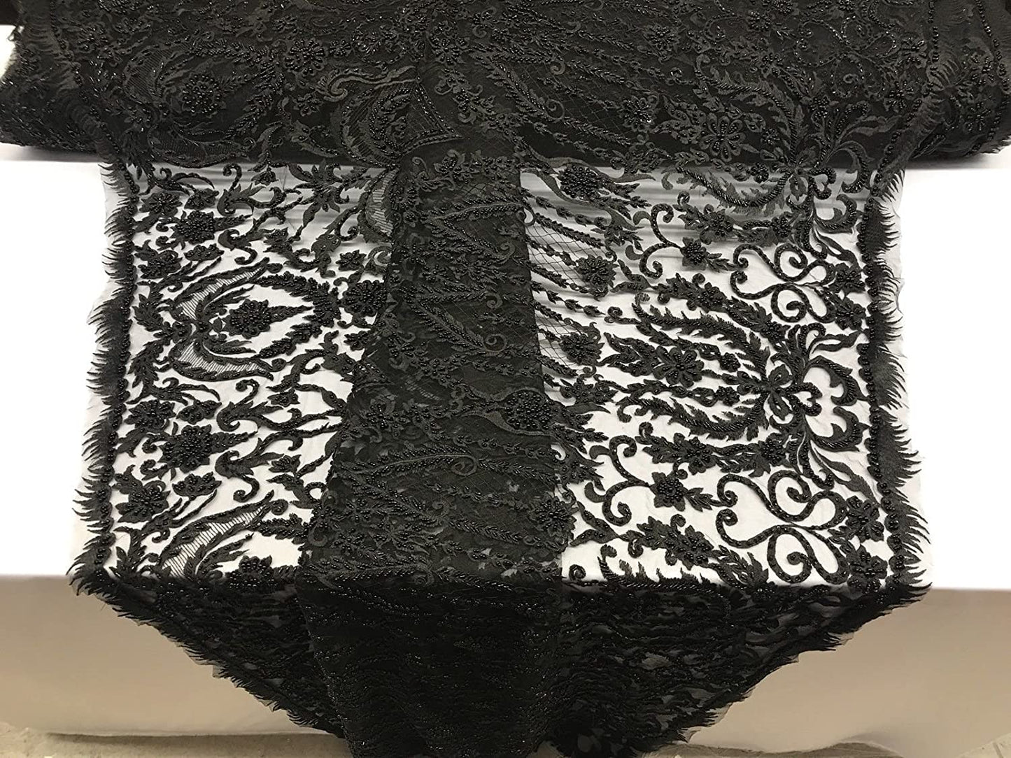 BLACK DIVA DESIGN EMBROIDERY WITH HEAVY BEADED ON A MESH-SOLD BY YARD.