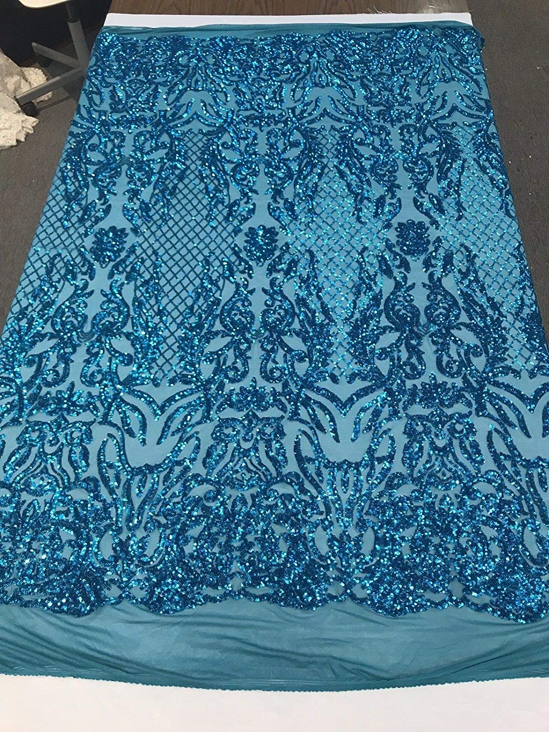 TURQUOISE SHINY SEQUIN DAMASK DESIGN EMBROIDERY ON A 4 WAY STRETCH MESH-1 YARD.
