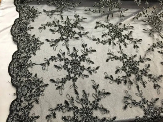Black/silver snowflake flower design embroider with sequins on a mesh lace. bridal/nightgown/prom fabric sold by the yard