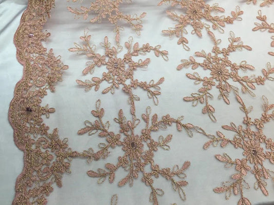 Peach/gold snowflake flower design embroider with sequins on a mesh lace. Wedding/prom/nightgown fabric sold by the yard