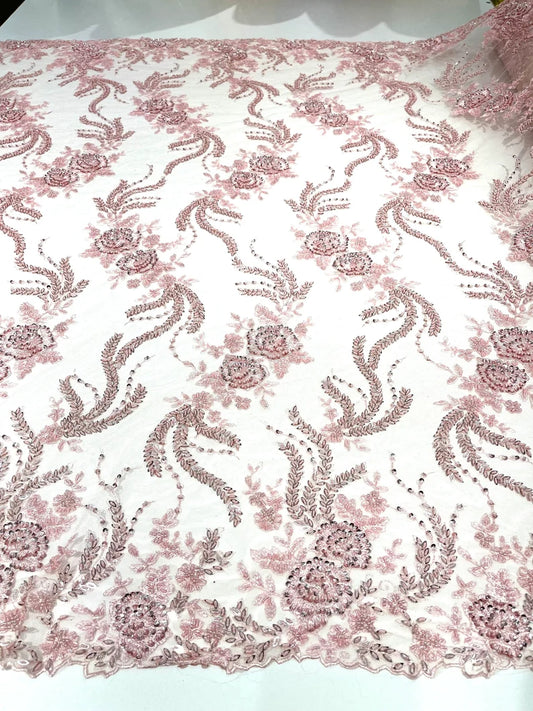 Pink flowers embroider and heavy beaded on a mesh lace fabric-sold by the yard.