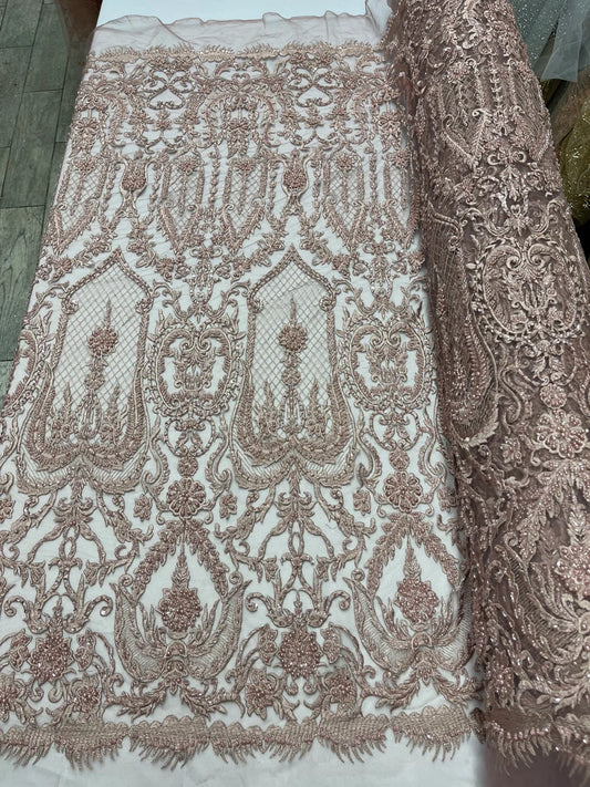 Mauve diva design embroidery with heavy beaded on a mesh lace-sold by the yard.
