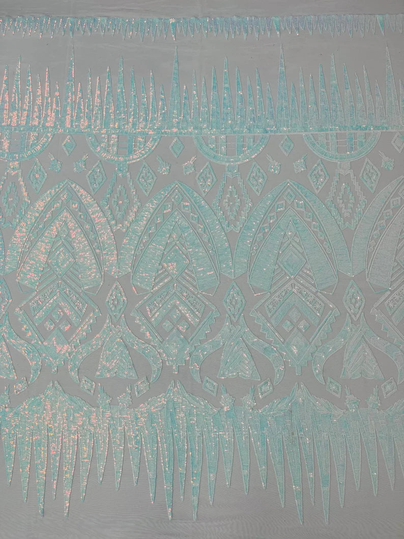 Clear aqua iridescent geometric Aztec design embroidery with sequins on a White 4 way stretch mesh fabric-sold by the yard.