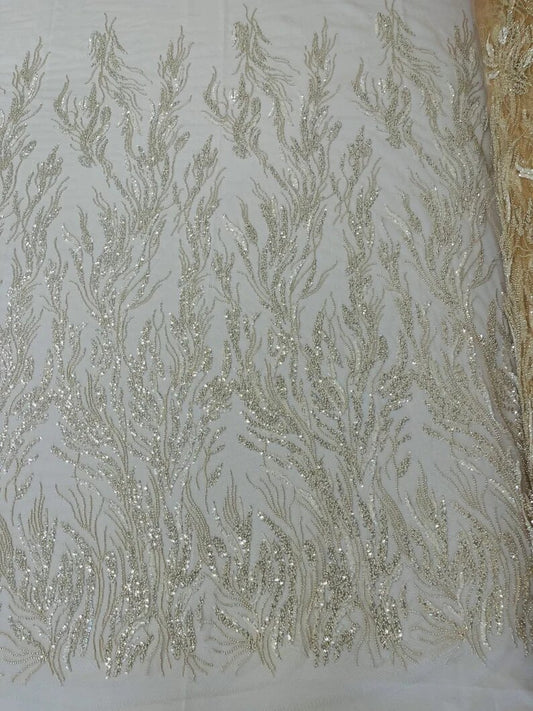 Fancy Design Embroider and heavy beading on a mesh lace-sold by the yard. Nude/Clear